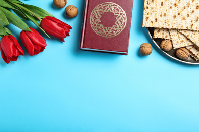 Photo of Flat lay composition with matzos on light blue background, space for text. Passover (Pesach) celebration