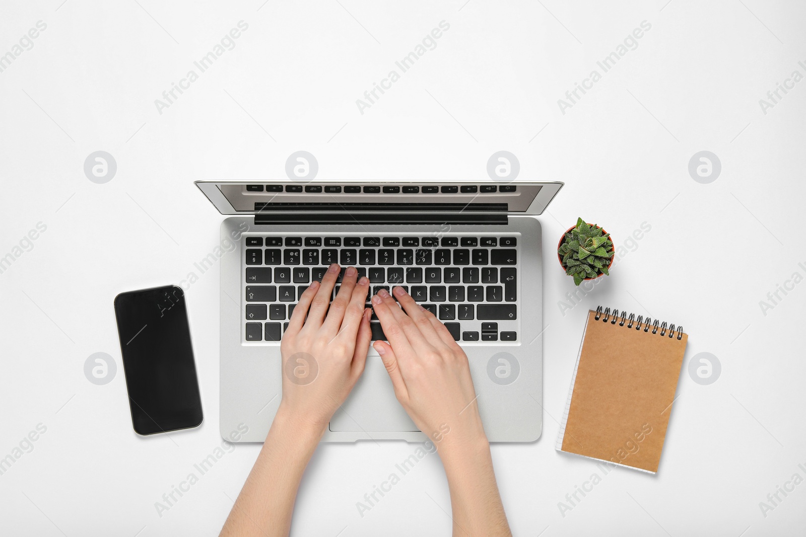 Photo of Woman using laptop at white table, top view