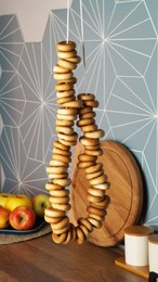 Photo of Bunch of delicious ring shaped Sushki (dry bagels) hanging in kitchen