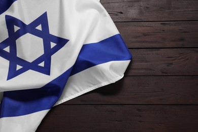 Flag of Israel on wooden background, top view and space for text. National symbol