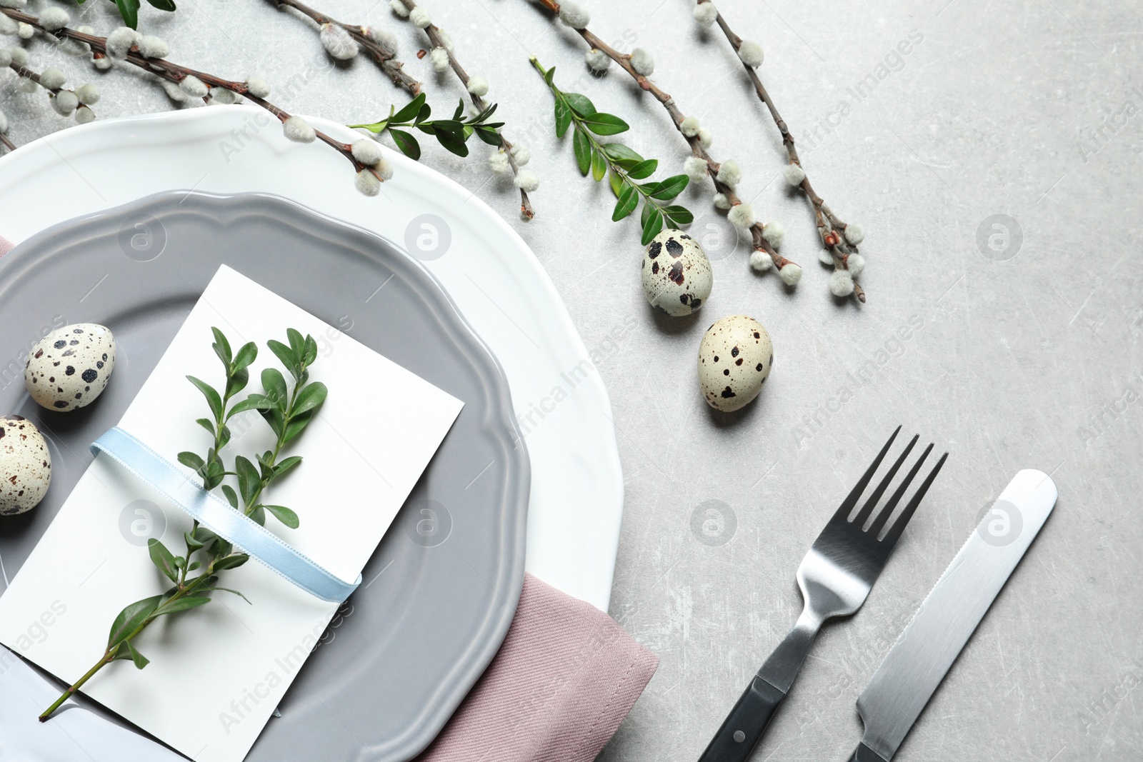 Photo of Festive Easter table setting with quail eggs on color background, flat lay