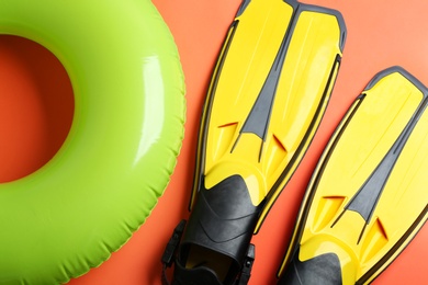 Flat lay composition with beach accessories on orange background