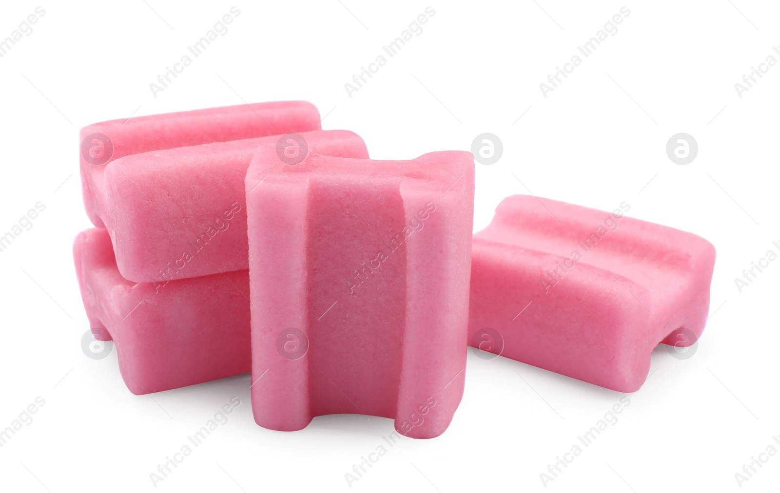 Photo of Many tasty pink chewing gums on white background