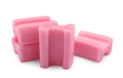 Photo of Many tasty pink chewing gums on white background