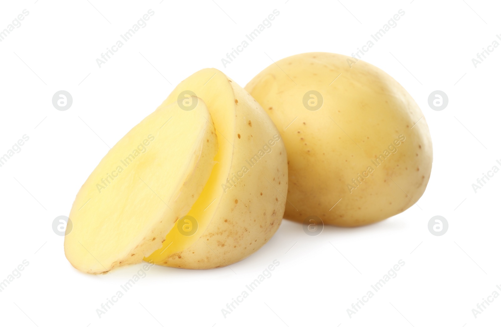 Photo of Whole and cut fresh raw organic potatoes on white background