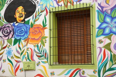 San Pedro Garza Garcia, Mexico – February 8, 2023: Building with beautiful traditional street art and window