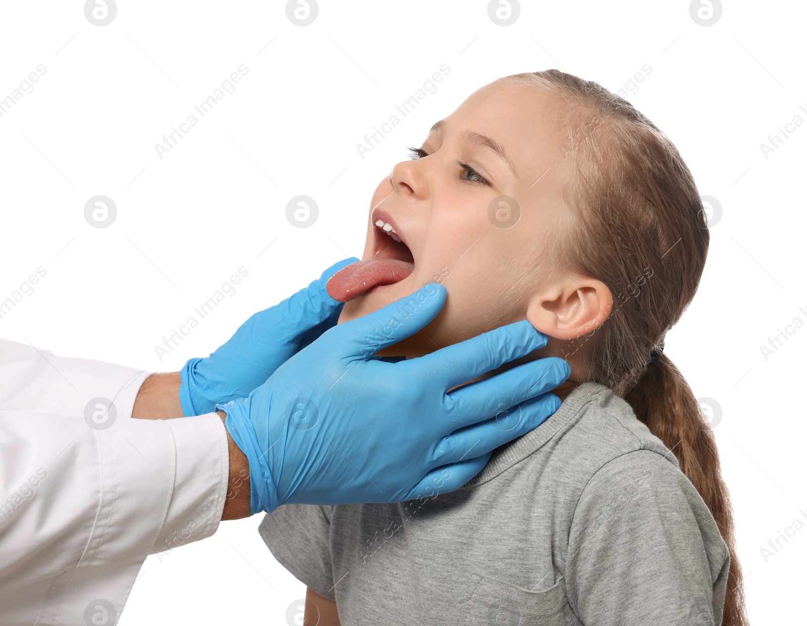 Photo of Doctor examining girl`s oral cavity on white background