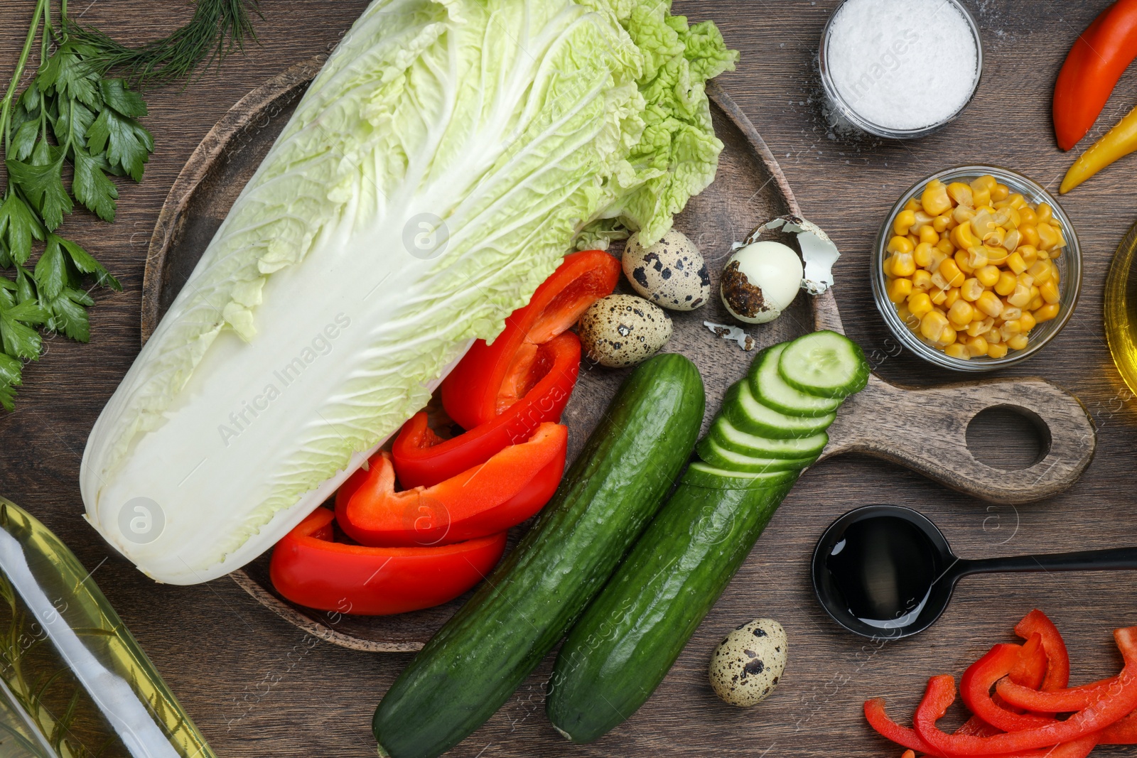 Photo of Chinese cabbage and different products on wooden table, flat lay