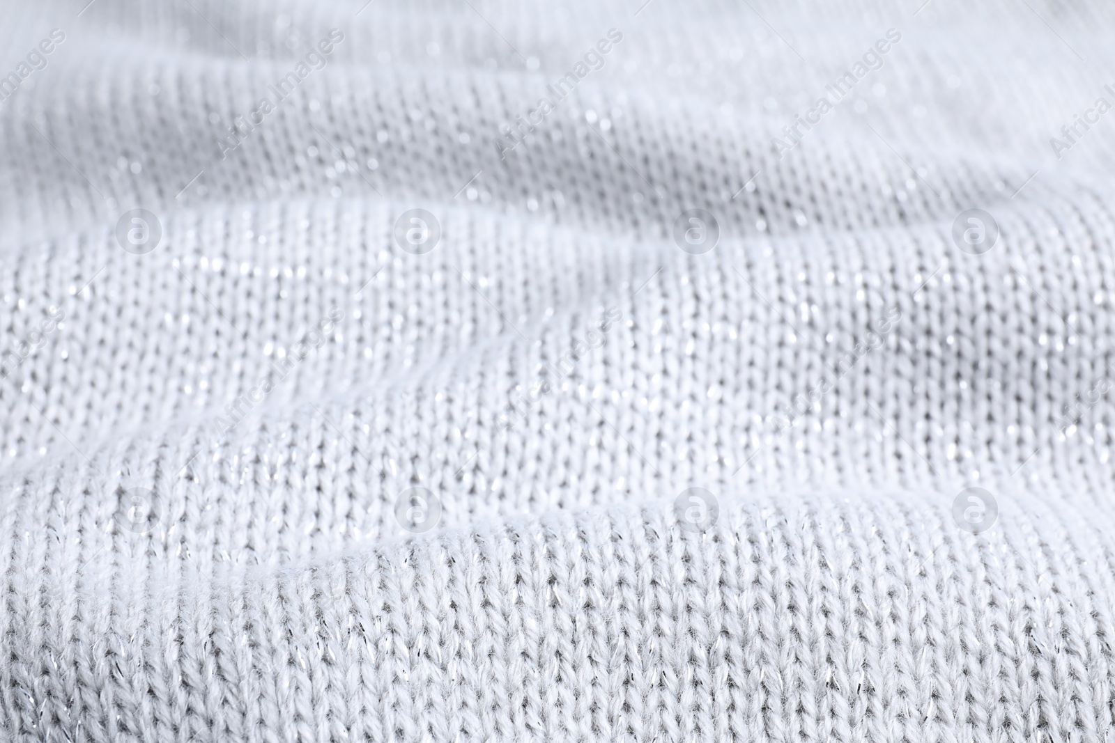 Photo of Warm knitted sweater as background, closeup view