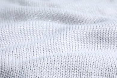 Warm knitted sweater as background, closeup view