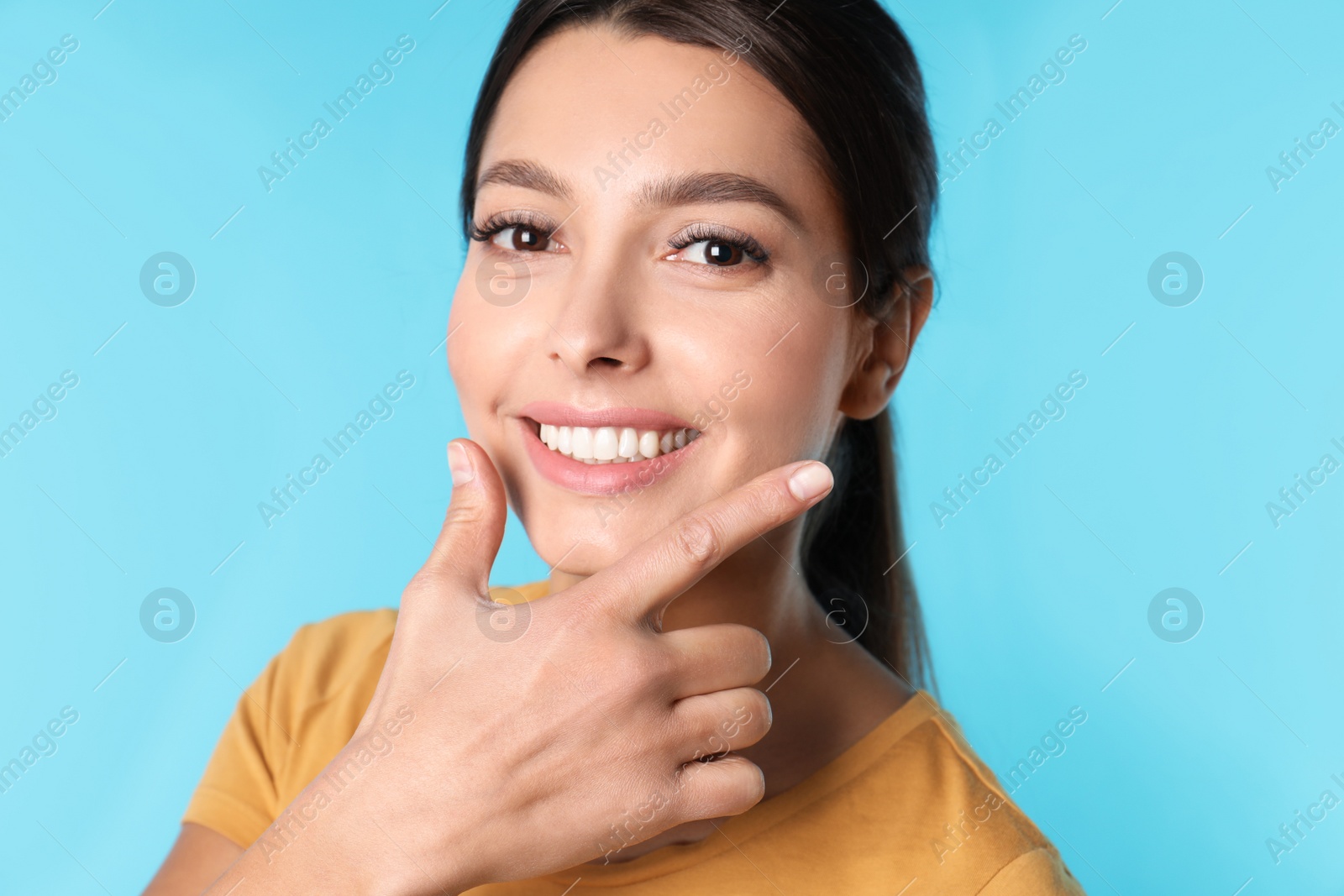 Photo of Young woman with healthy teeth on color background