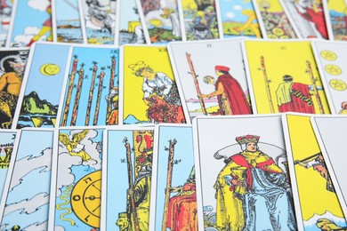 Photo of Many different tarot cards as background, closeup