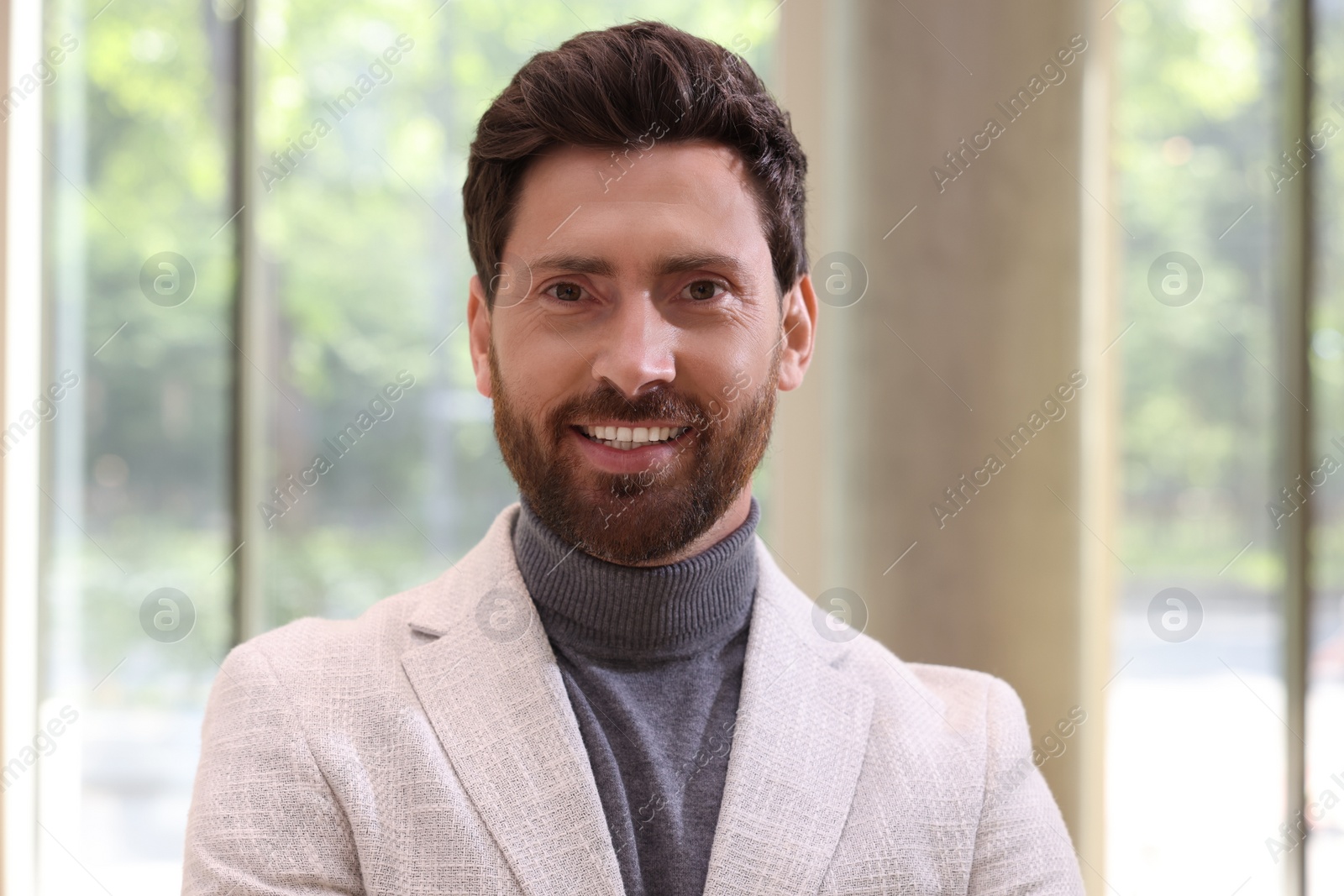 Photo of Portrait of handsome stylish man in office