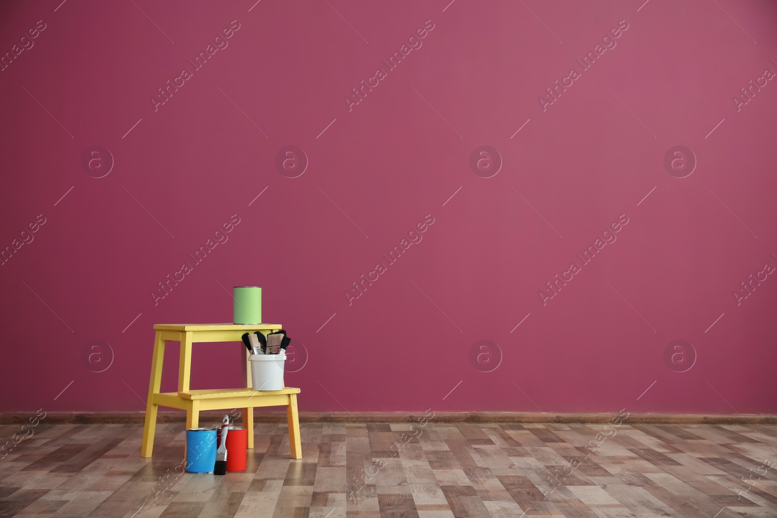 Photo of Decorator's tools near color wall