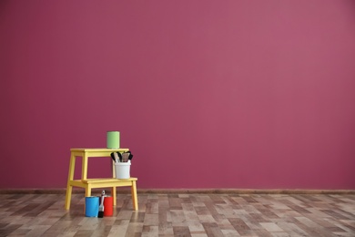 Photo of Decorator's tools near color wall