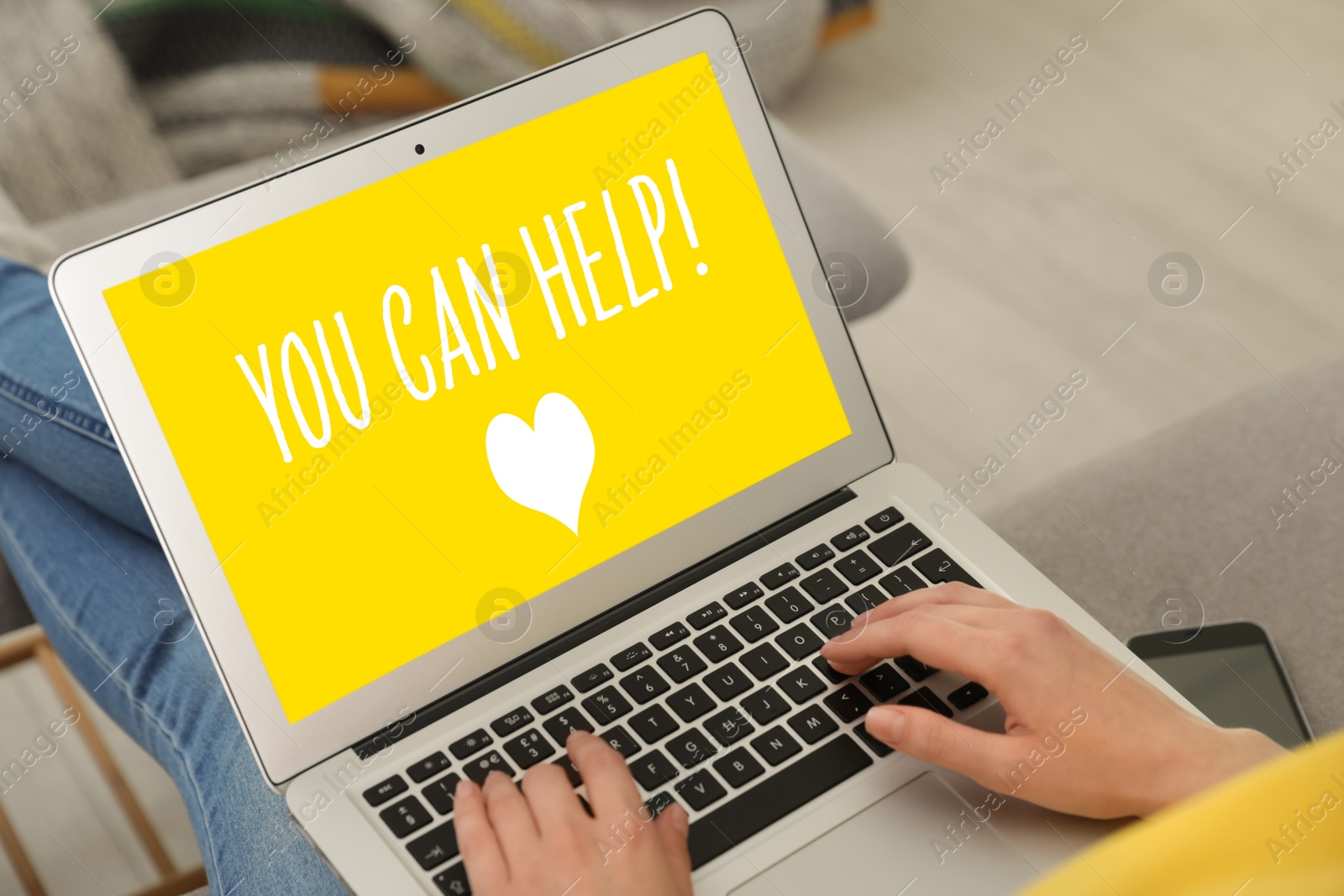 Image of Donations concept. Woman holding laptop with text YOU CAN HELP indoors, closeup