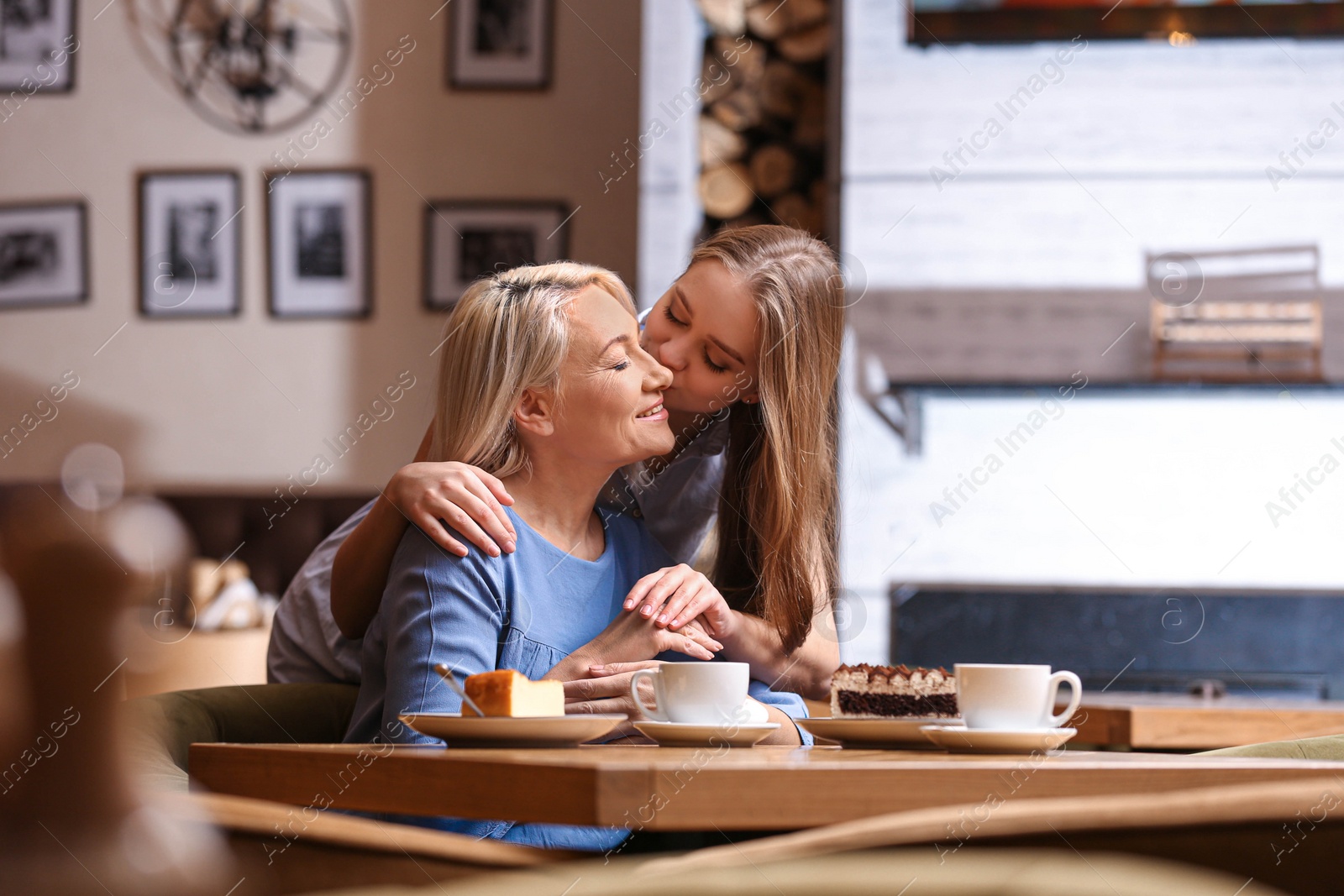 Photo of Mother and her adult daughter spending time together in cafe