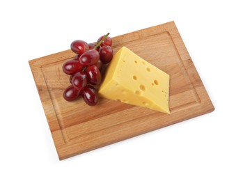 Photo of Piece of delicious cheese and grapes isolated on white, above view