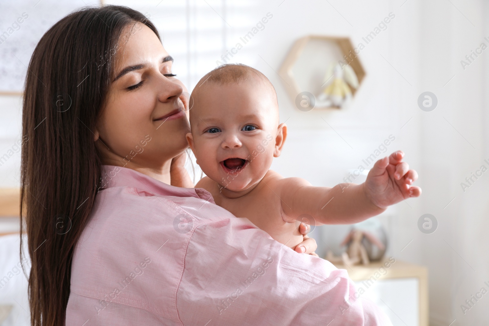 Photo of Mother with her cute baby at home