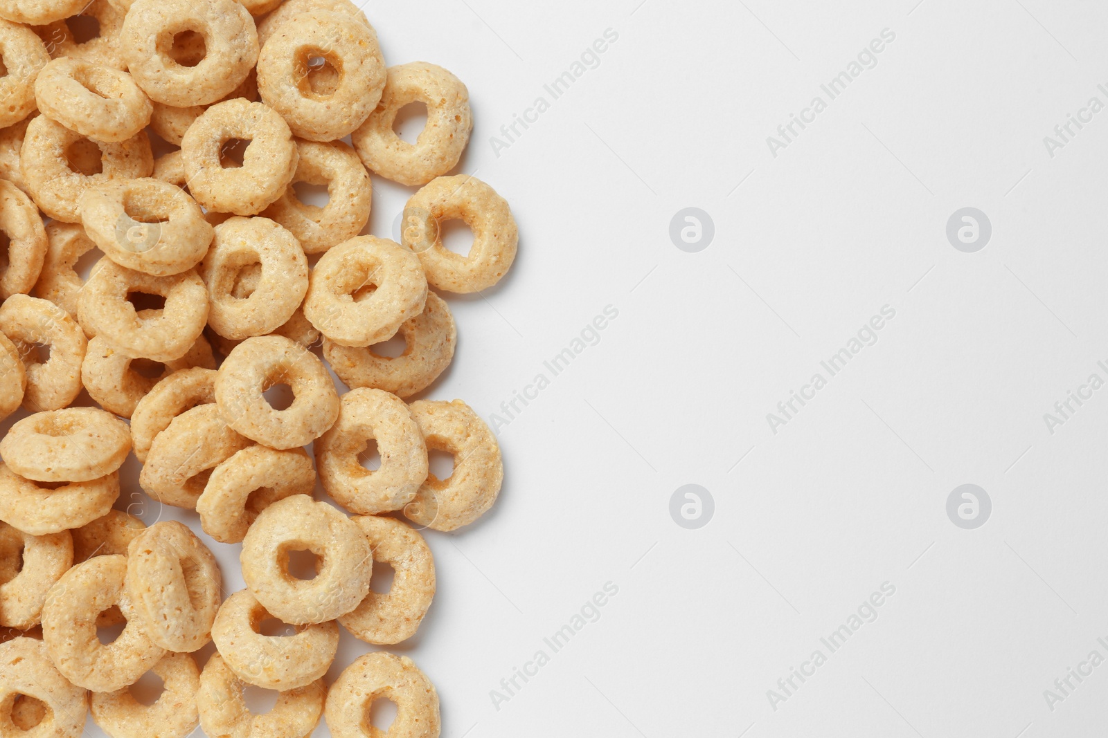 Photo of Sweet tasty corn rings on white background, top view