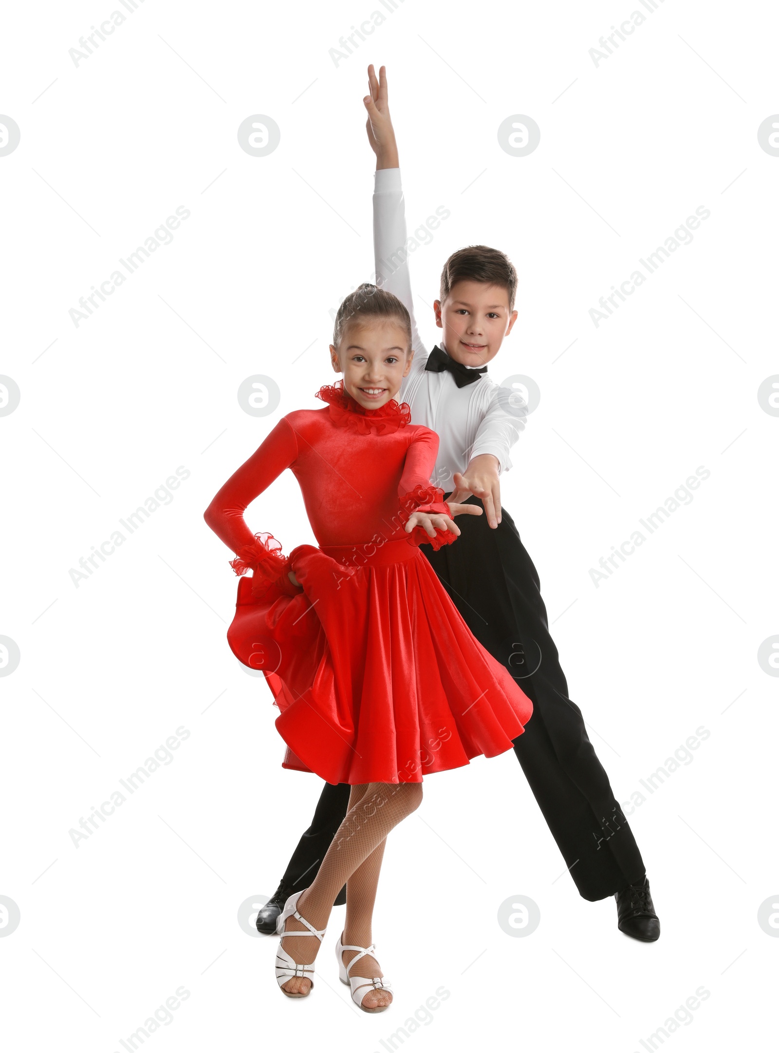 Photo of Beautifully dressed couple of kids dancing on white background