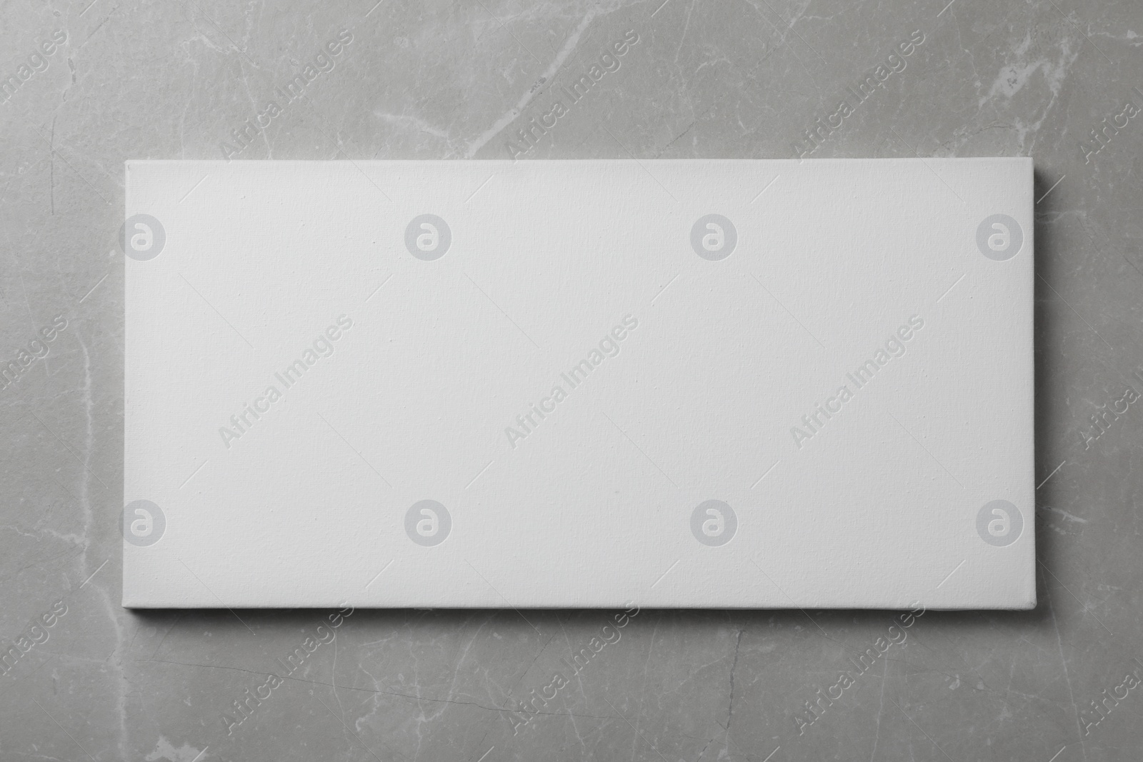 Photo of Blank canvas on grey stone background, space for text
