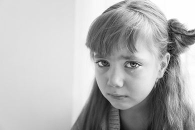 Photo of Portrait of sad little girl, black and white effect