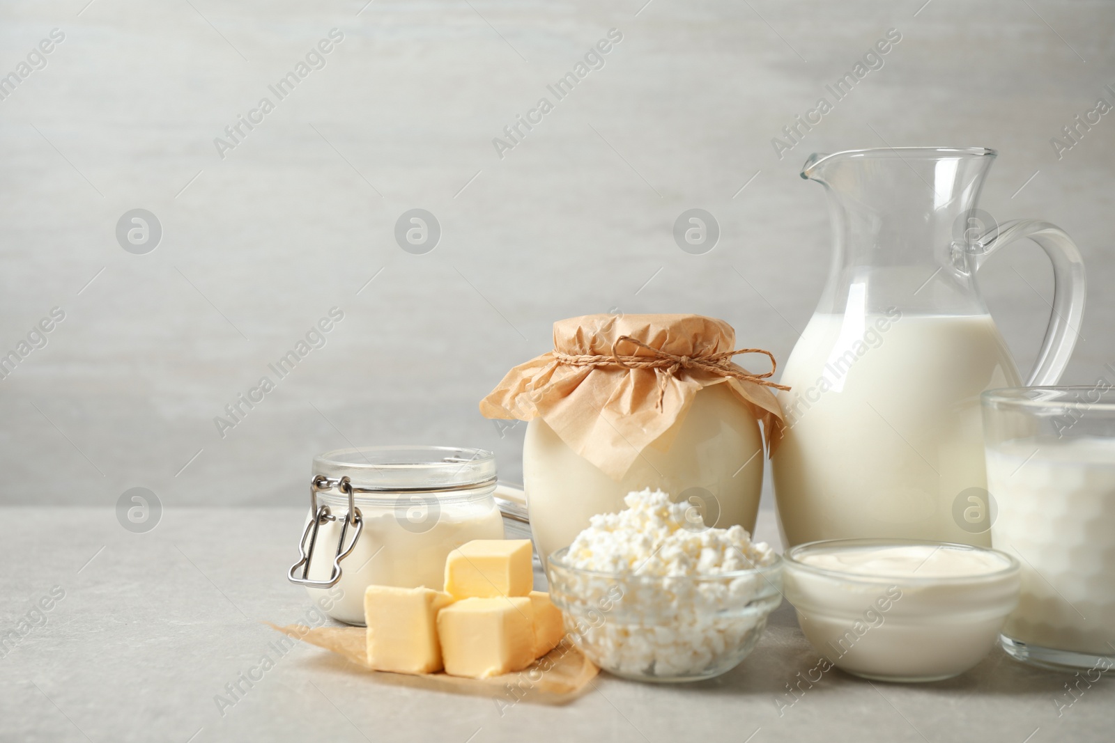 Photo of Different dairy products on light table. Space for text