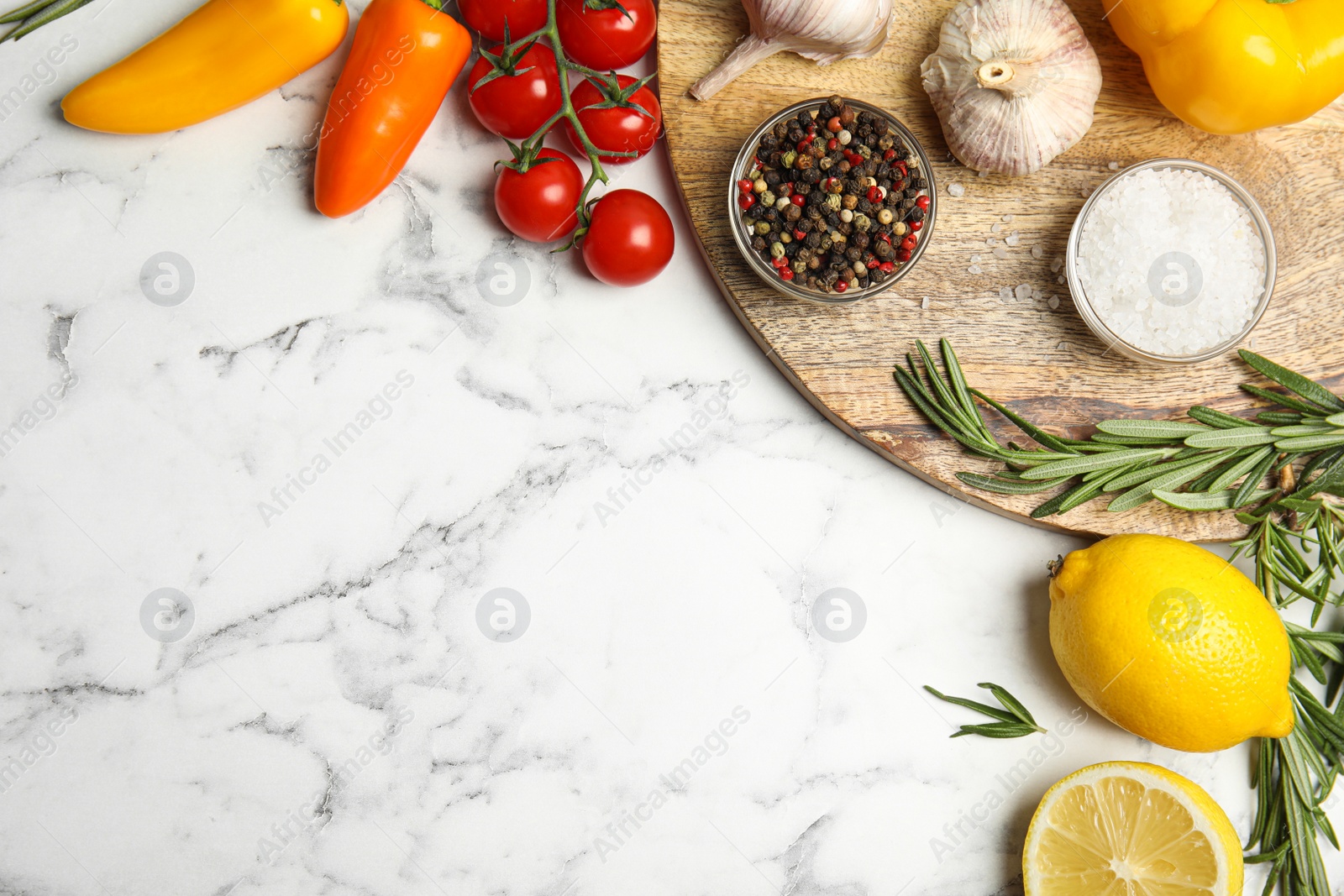 Photo of Flat lay composition with ingredients for cooking on white marble table. Space for text