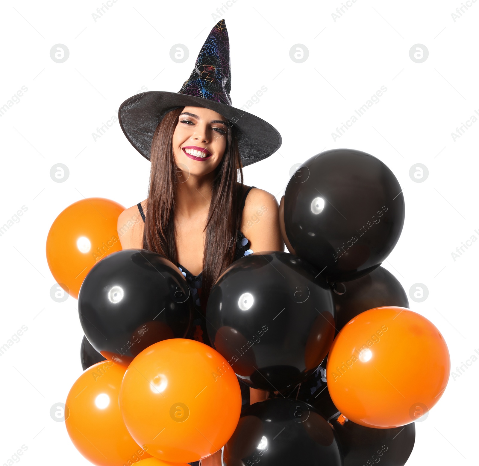 Photo of Beautiful woman wearing witch costume with balloons for Halloween party on white background