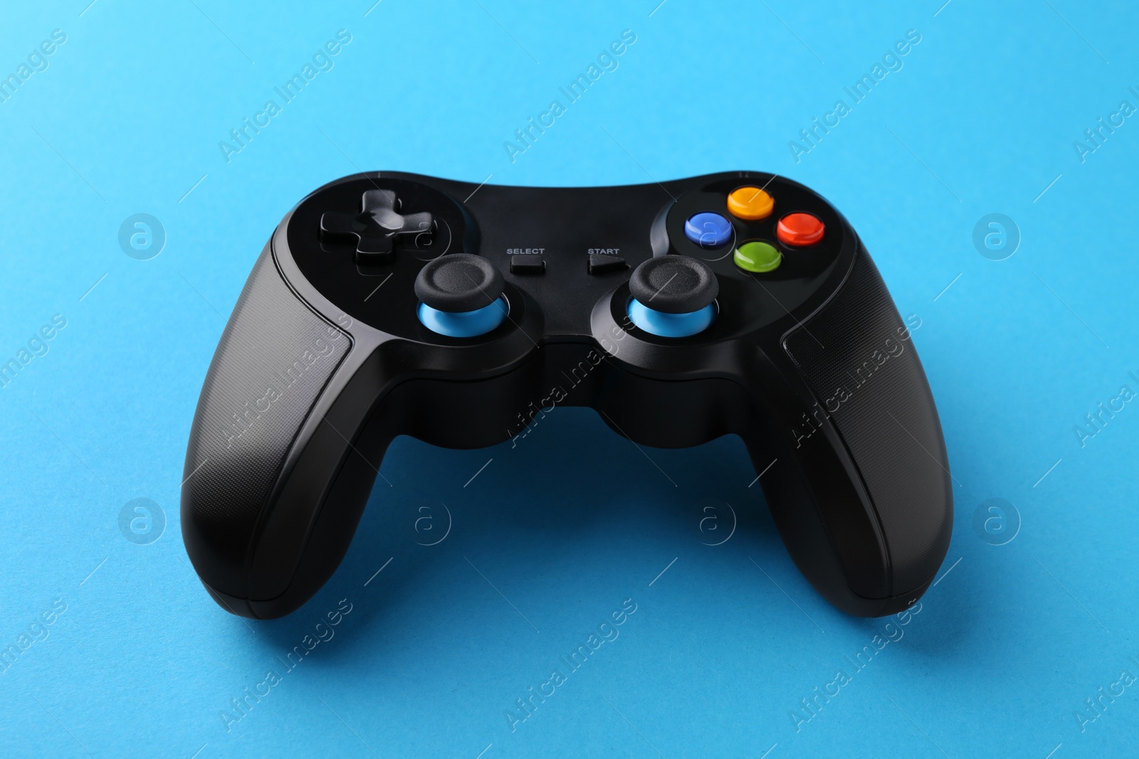 Photo of Wireless game controller on light blue background