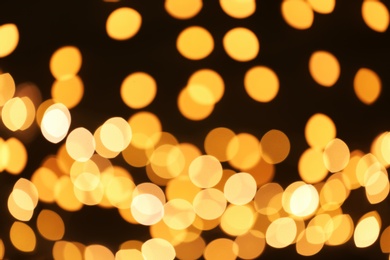 Photo of Beautiful golden lights on dark background. Bokeh effect