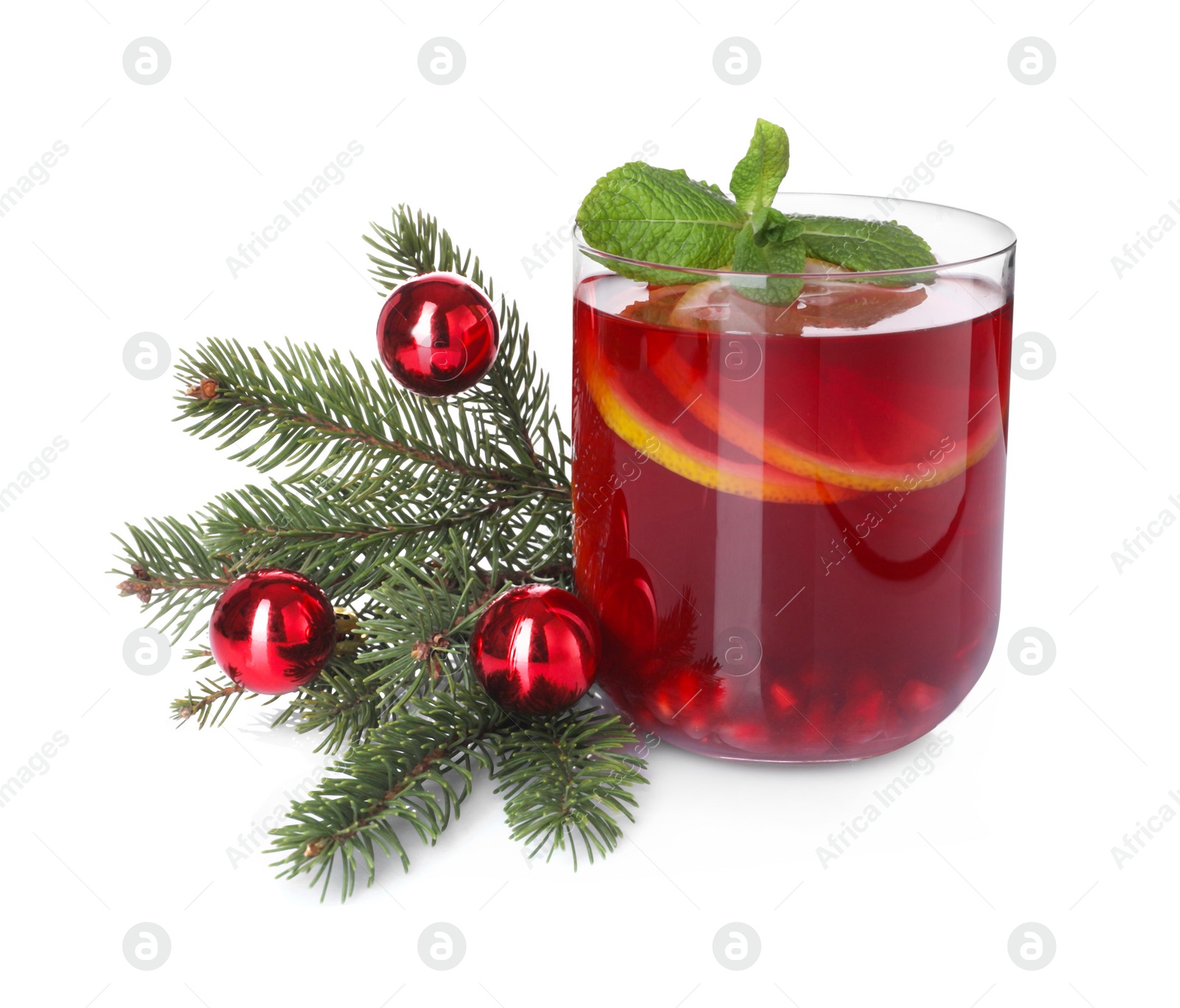 Photo of Christmas Sangria drink in glass, fir branch and baubles on white background