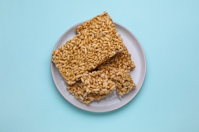 Photo of Puffed rice bars (kozinaki) on light blue background, top view