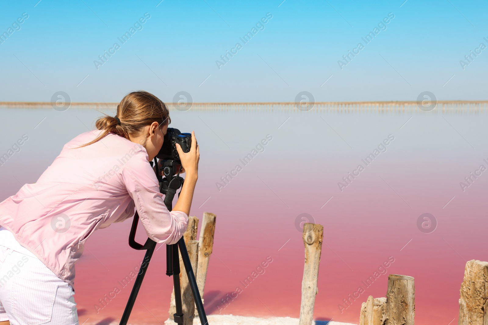 Photo of Professional photographer taking photo of pink lake on sunny day