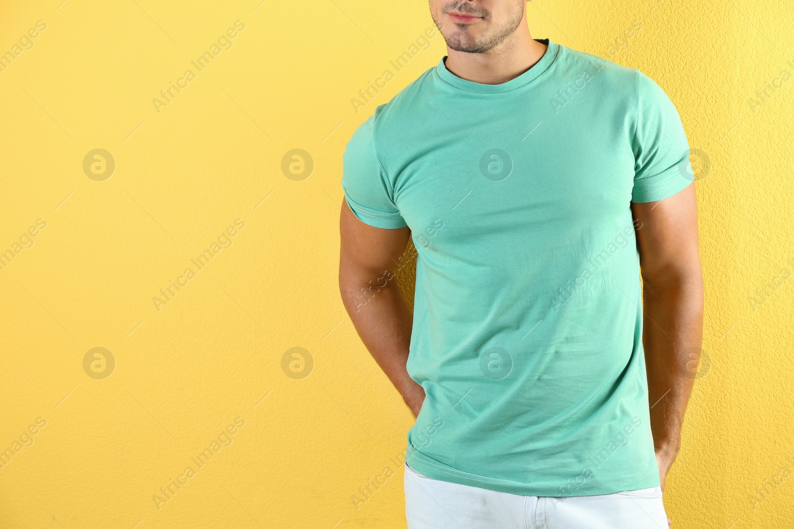 Photo of Young man in t-shirt on color background. Mockup for design