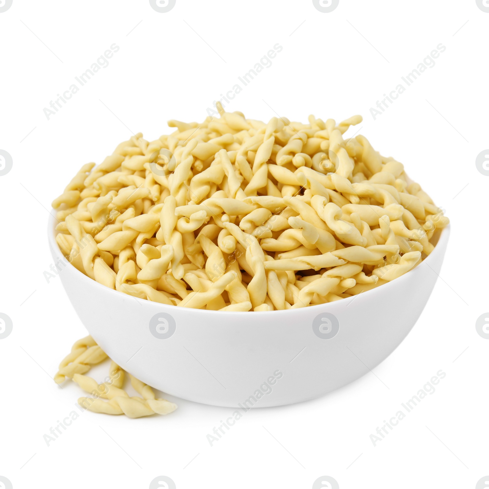 Photo of Bowl with uncooked trofie pasta isolated on white
