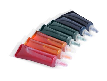 Photo of Tubes with different food coloring on white background