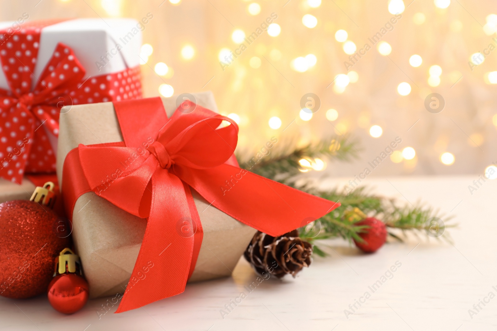 Photo of Christmas gifts and decoration on table against blurred background