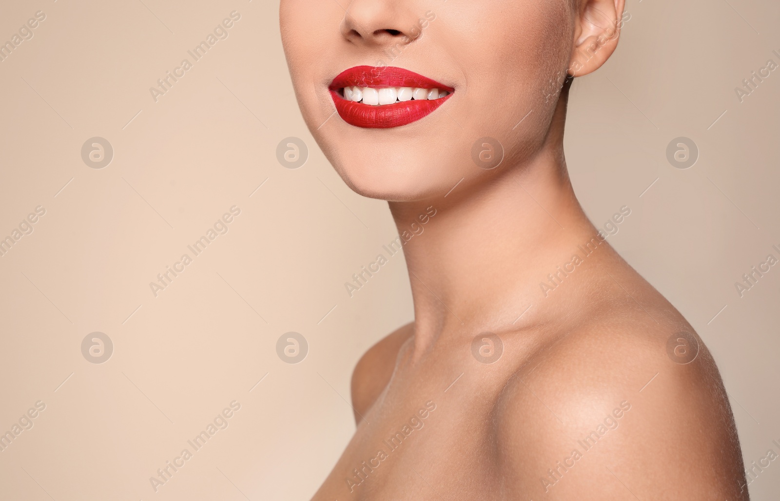 Photo of Beautiful young woman with red lips on color background, closeup. Space for text