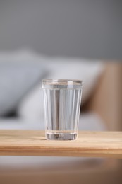 Glass of pure water on wooden table indoors
