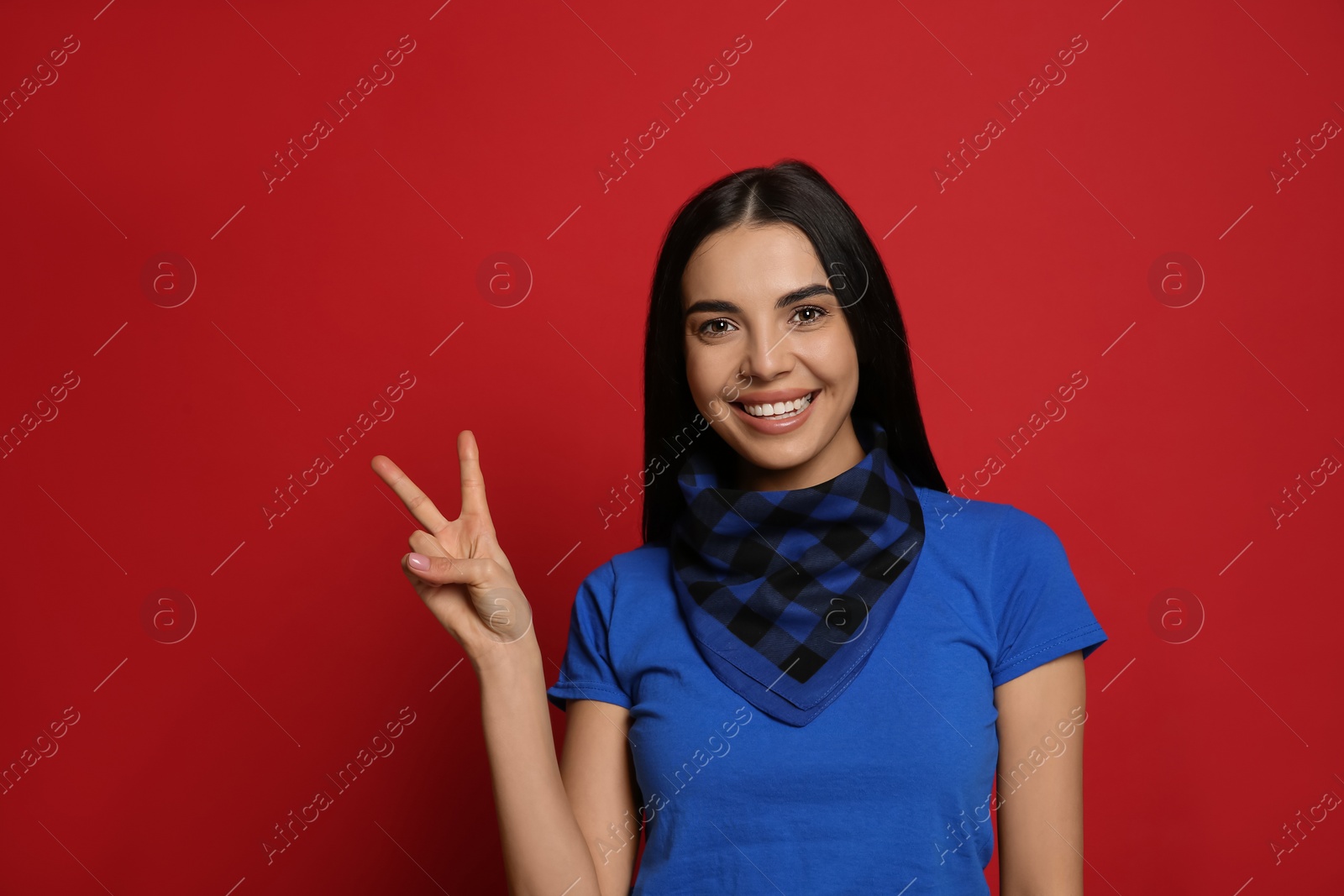 Photo of Young woman wearing stylish bandana on red background, space for text