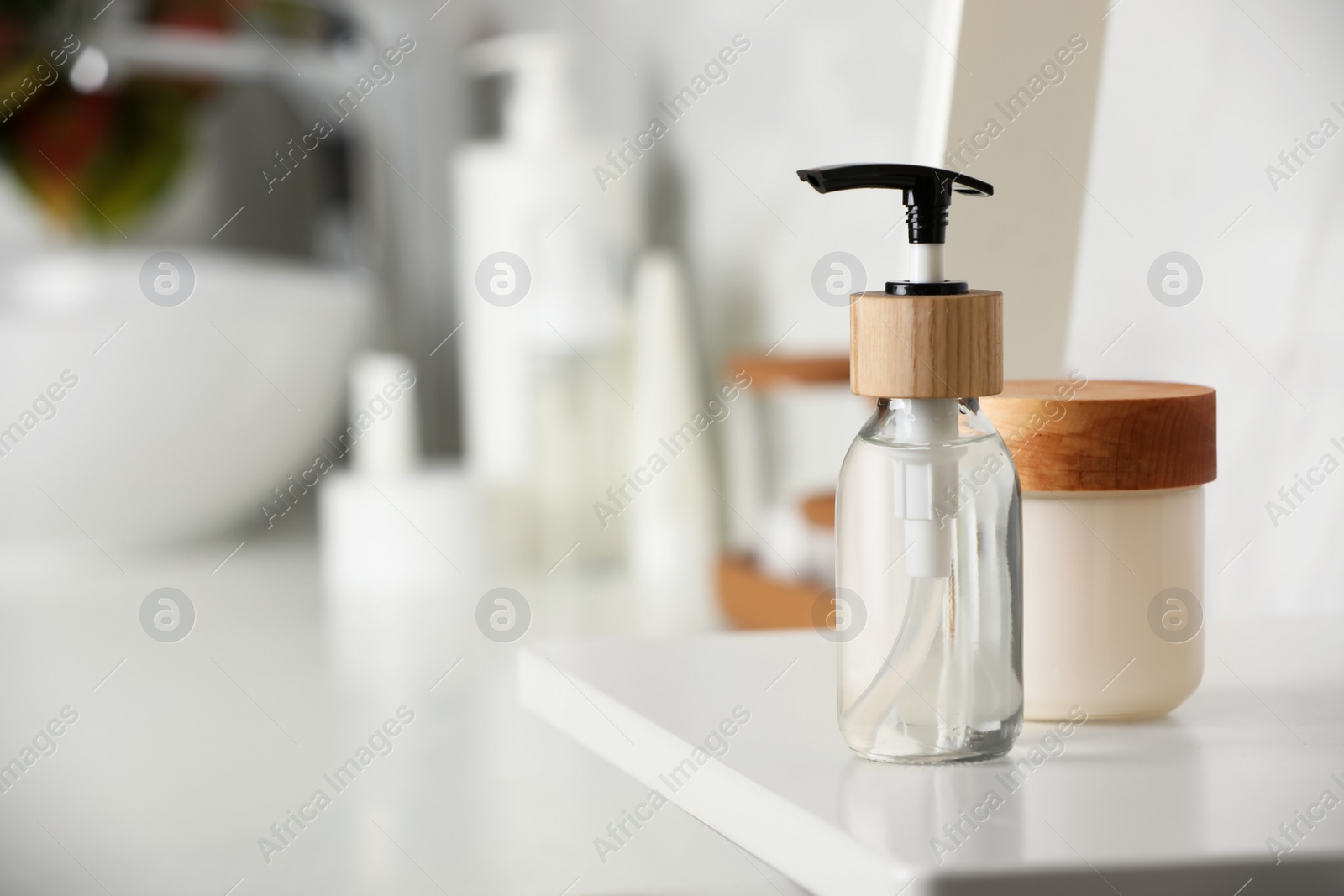 Photo of Different personal care products on shelf in bathroom. Space for text