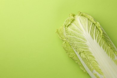 Fresh ripe Chinese cabbage on light green background, top view. Space for text