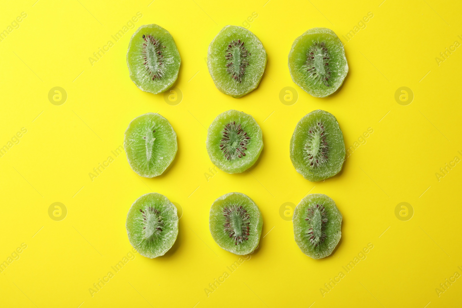 Photo of Slices of kiwi on color background, flat lay. Dried fruit as healthy food