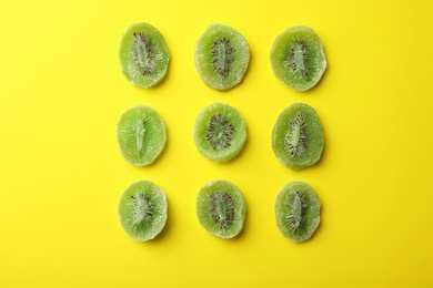 Slices of kiwi on color background, flat lay. Dried fruit as healthy food