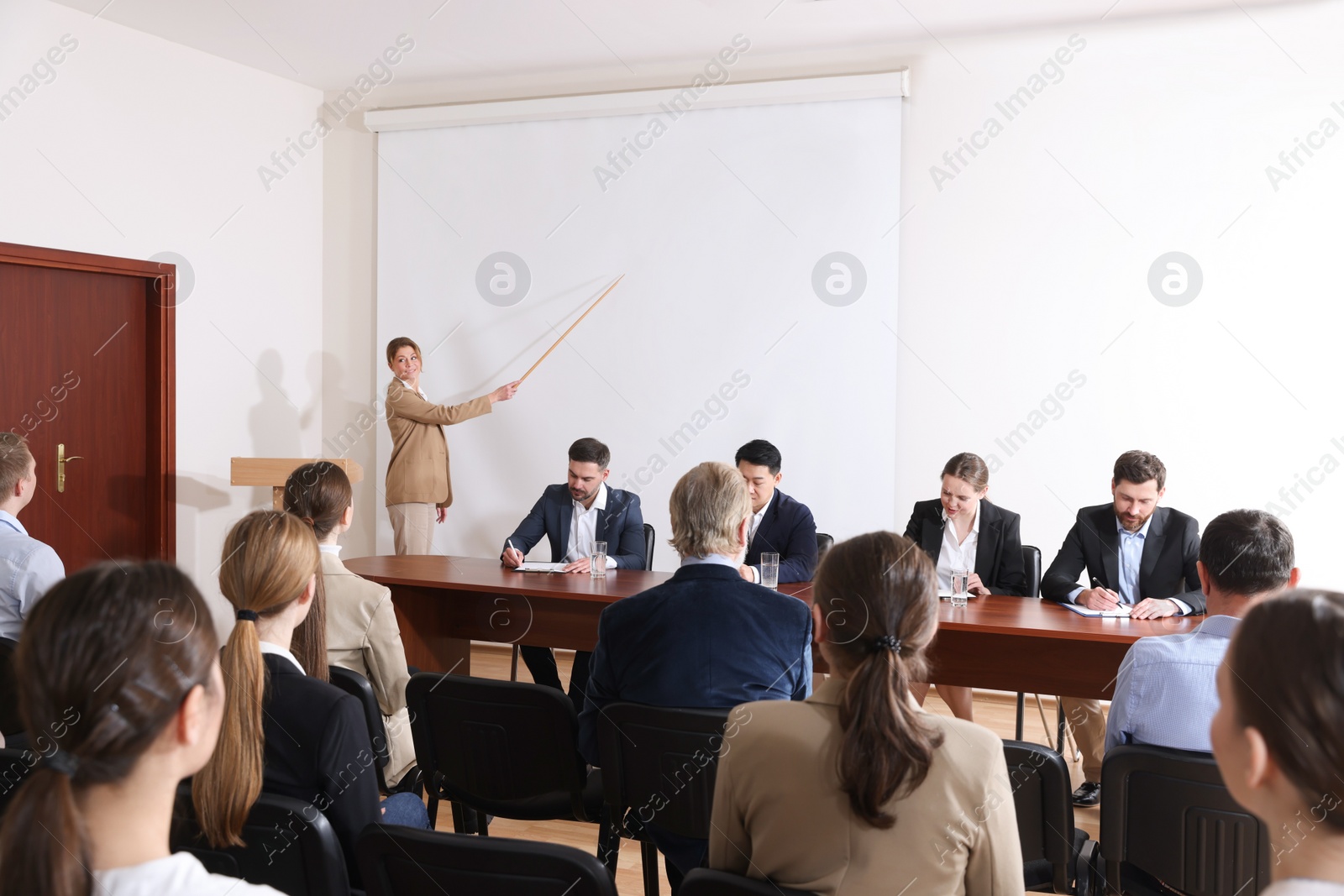 Photo of Business conference. People in meeting room listening to speaker report