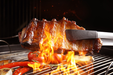 Image of Delicious ribs and vegetables on barbecue grill