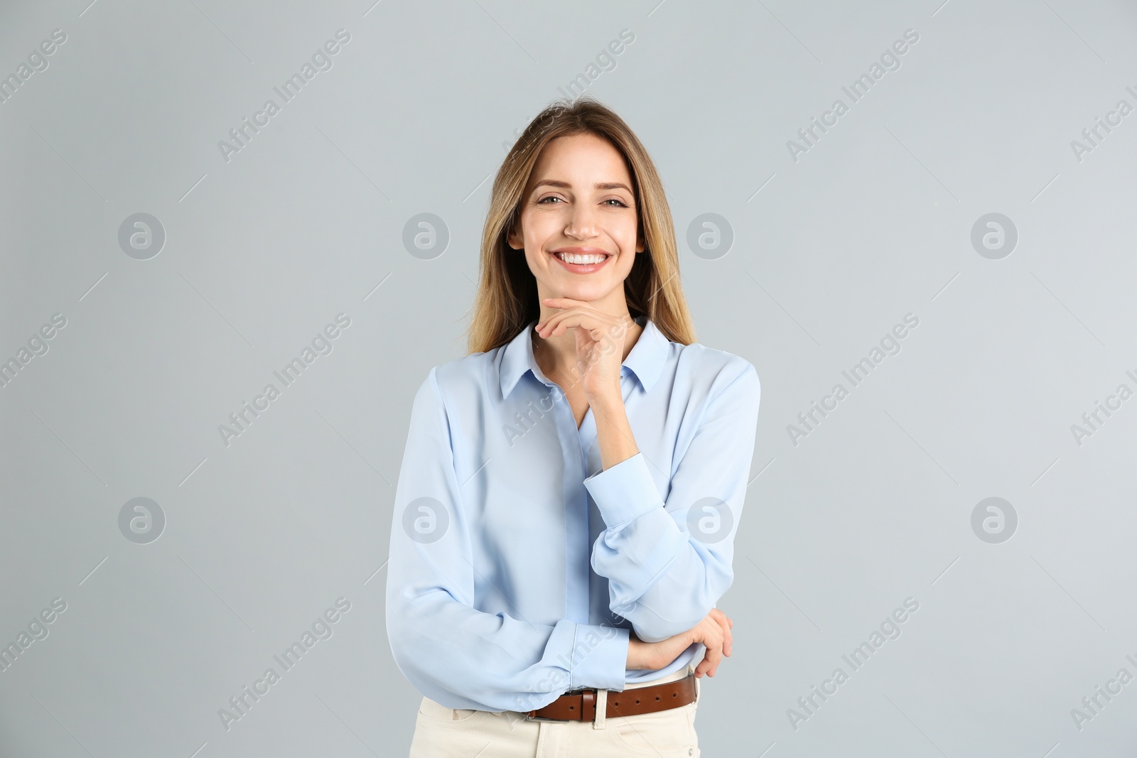 Photo of Portrait of beautiful young businesswoman on light grey background