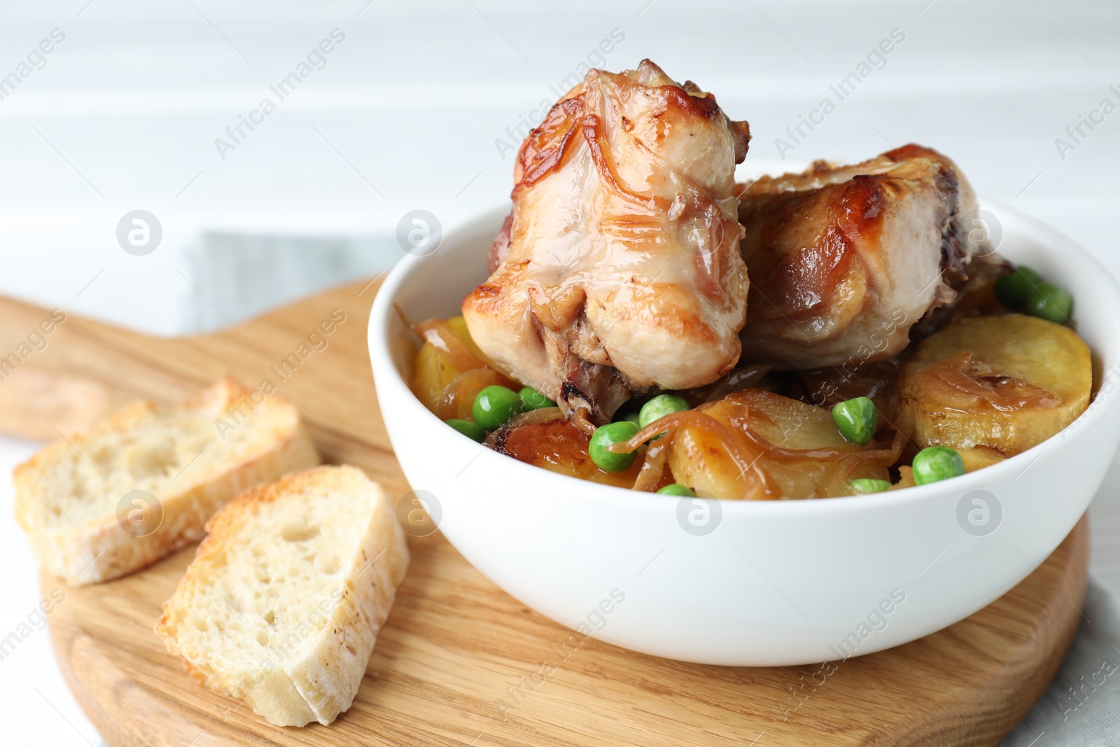 Photo of Tasty cooked rabbit with vegetables in bowl on table, closeup